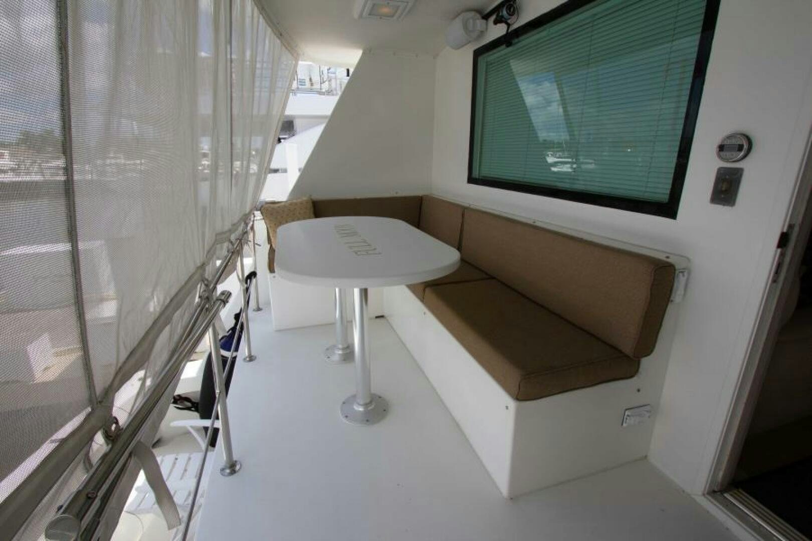a room with a stool and a table and a window aboard FULL MOON Yacht for Sale