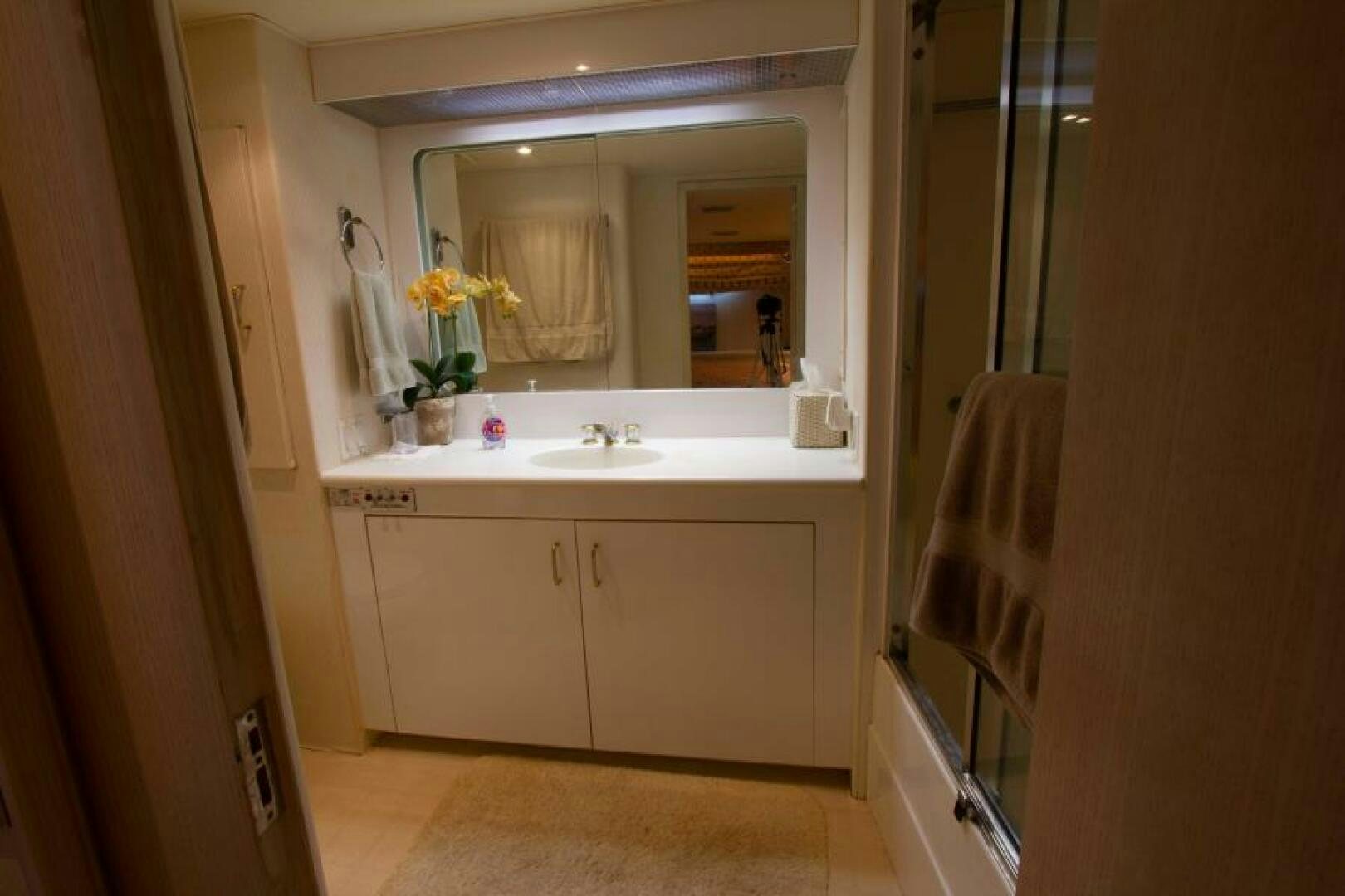 a bathroom with a sink and mirror aboard FULL MOON Yacht for Sale