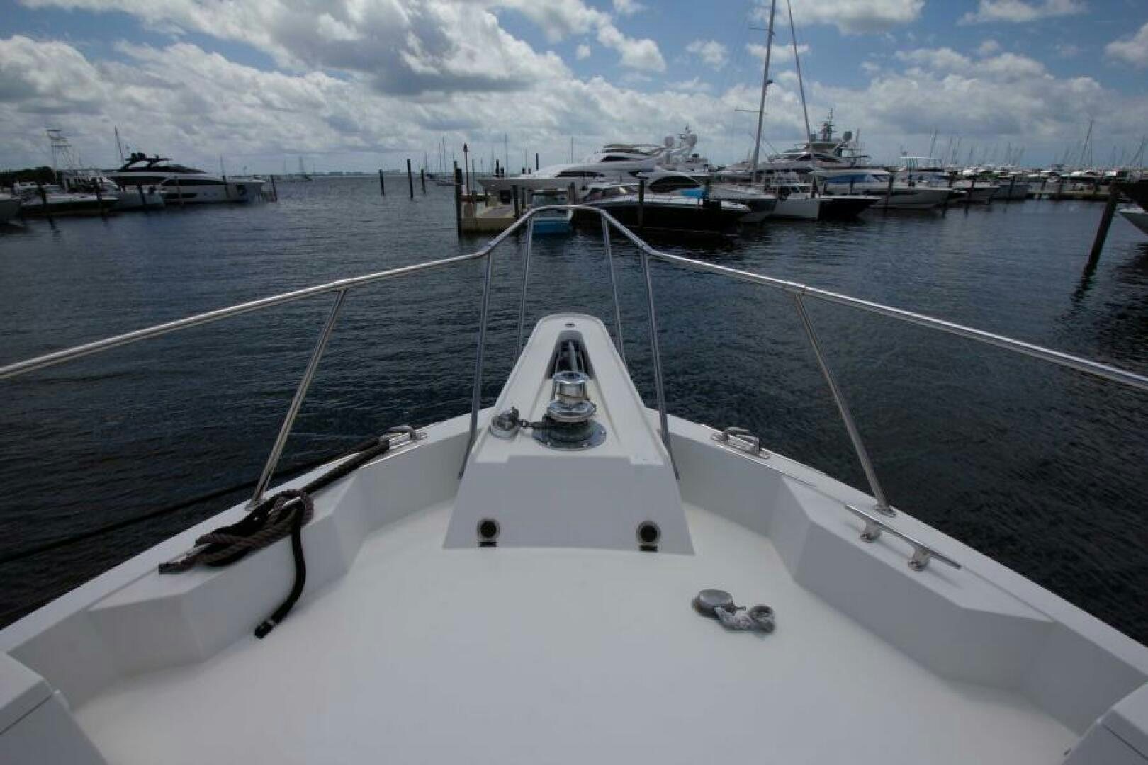 a white boat in a harbor aboard FULL MOON Yacht for Sale