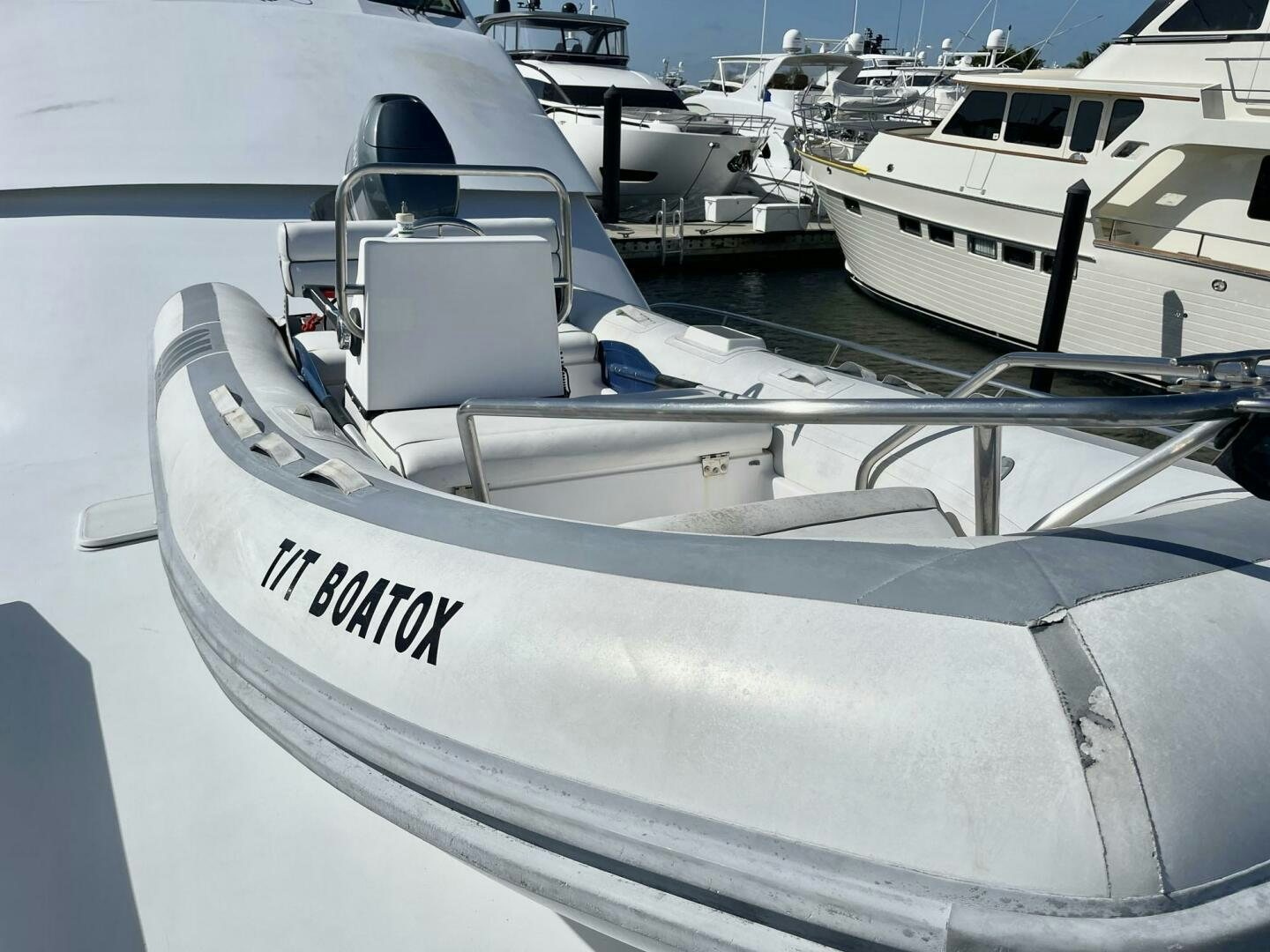 a white boat with a black stripe aboard BOATOX Yacht for Sale