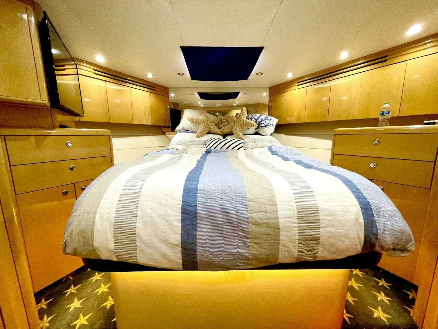 a bed with a blue blanket aboard BOATOX Yacht for Sale