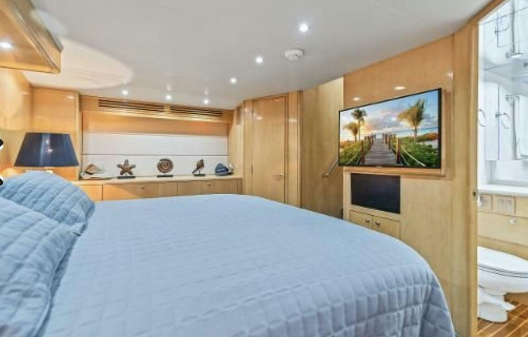 a bedroom with a bed and a television aboard BOATOX Yacht for Sale