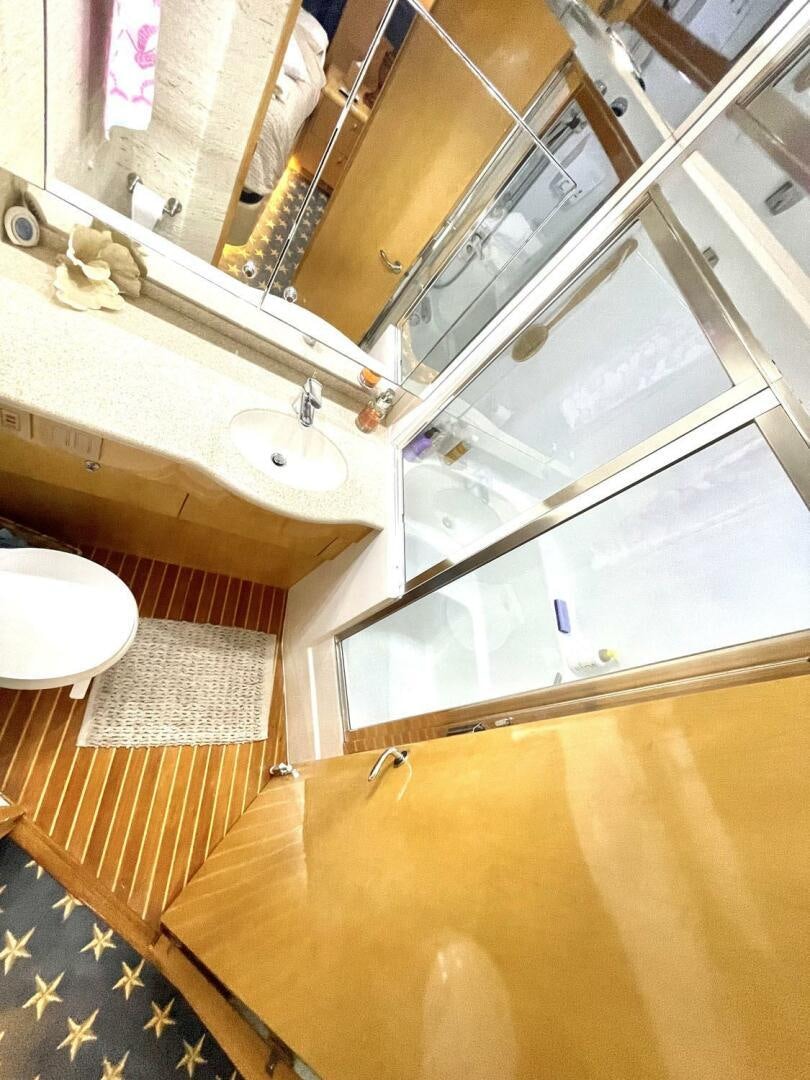 a bathroom with a large mirror aboard BOATOX Yacht for Sale