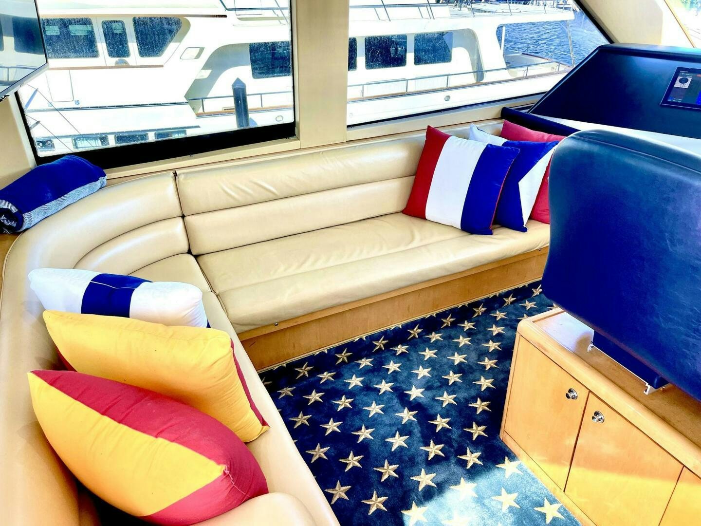 a couch and a table in a room with a window aboard BOATOX Yacht for Sale