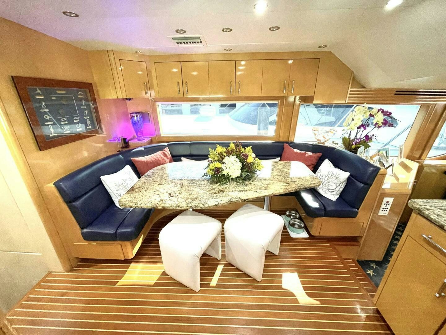 a room with a table and chairs aboard BOATOX Yacht for Sale