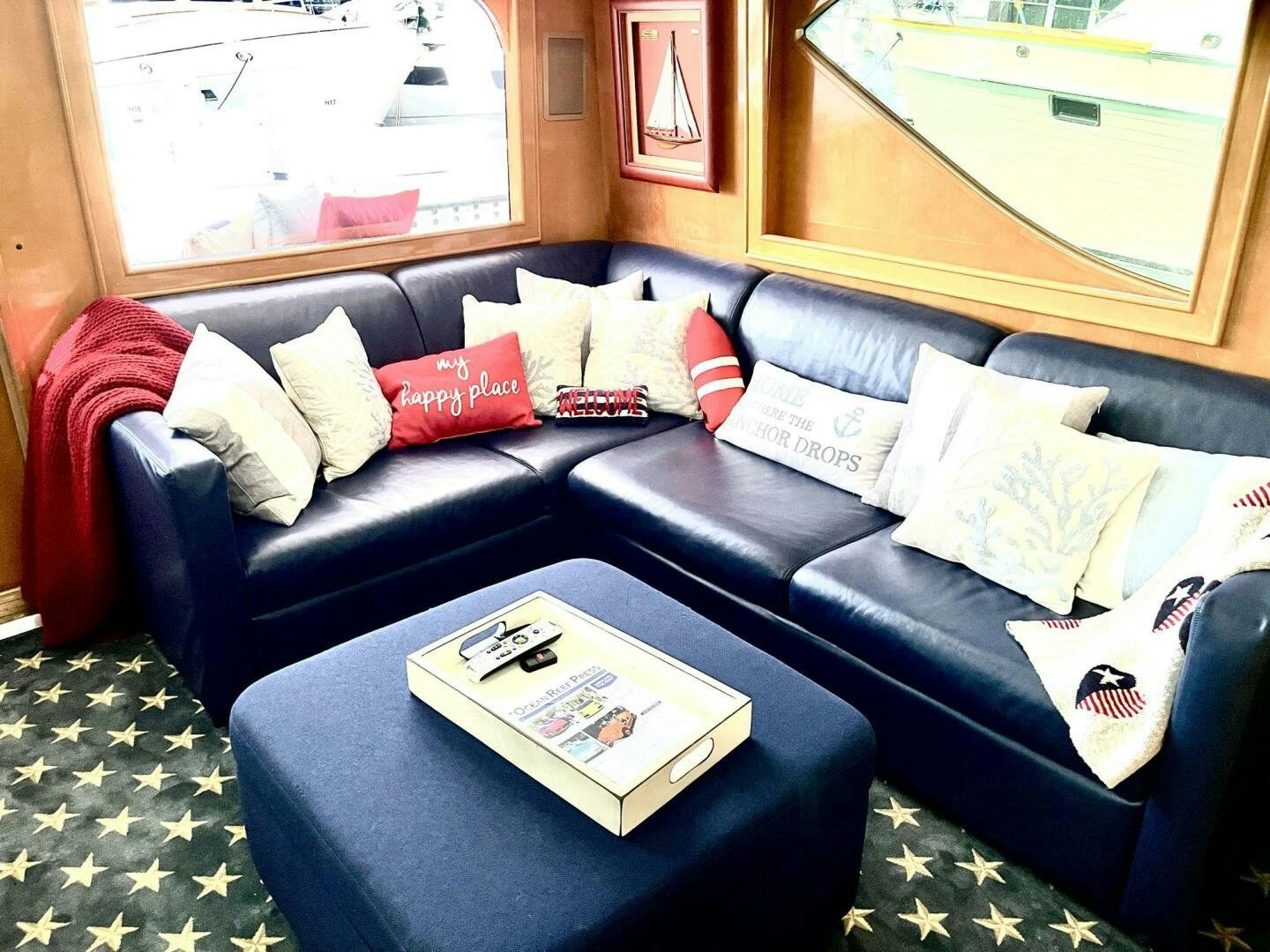 a couch with pillows and a coffee table in front of it aboard BOATOX Yacht for Sale