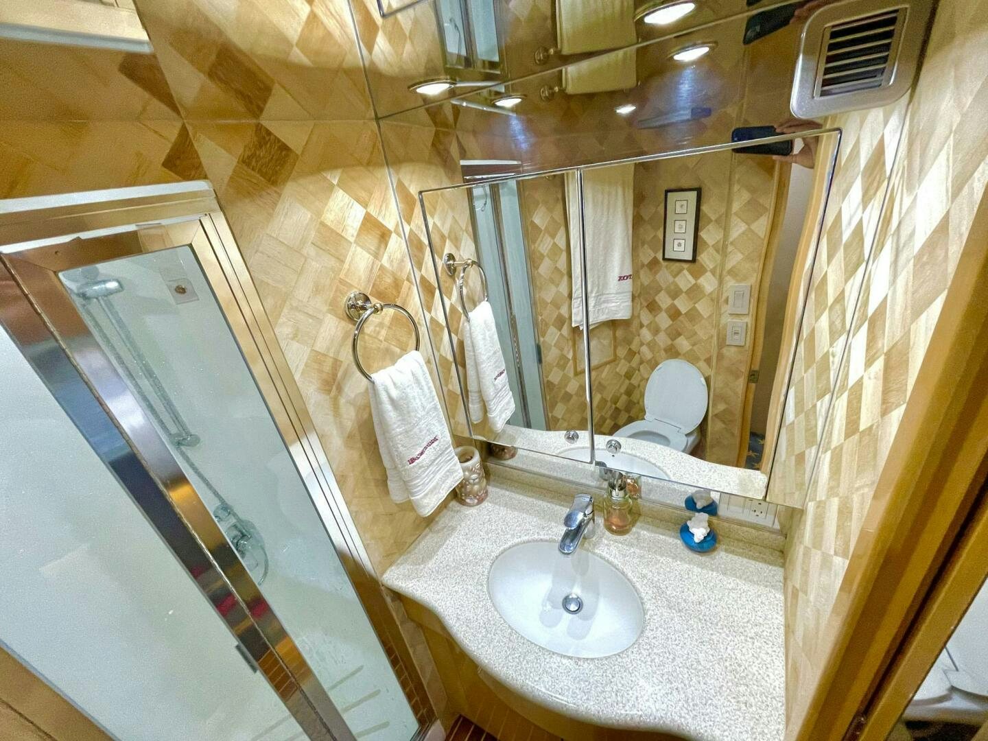 a bathroom with a large mirror aboard BOATOX Yacht for Sale
