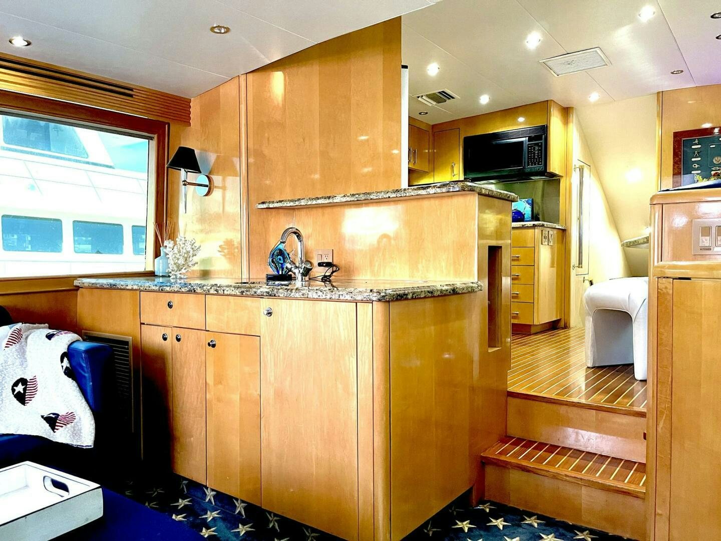 a kitchen with wooden cabinets aboard BOATOX Yacht for Sale