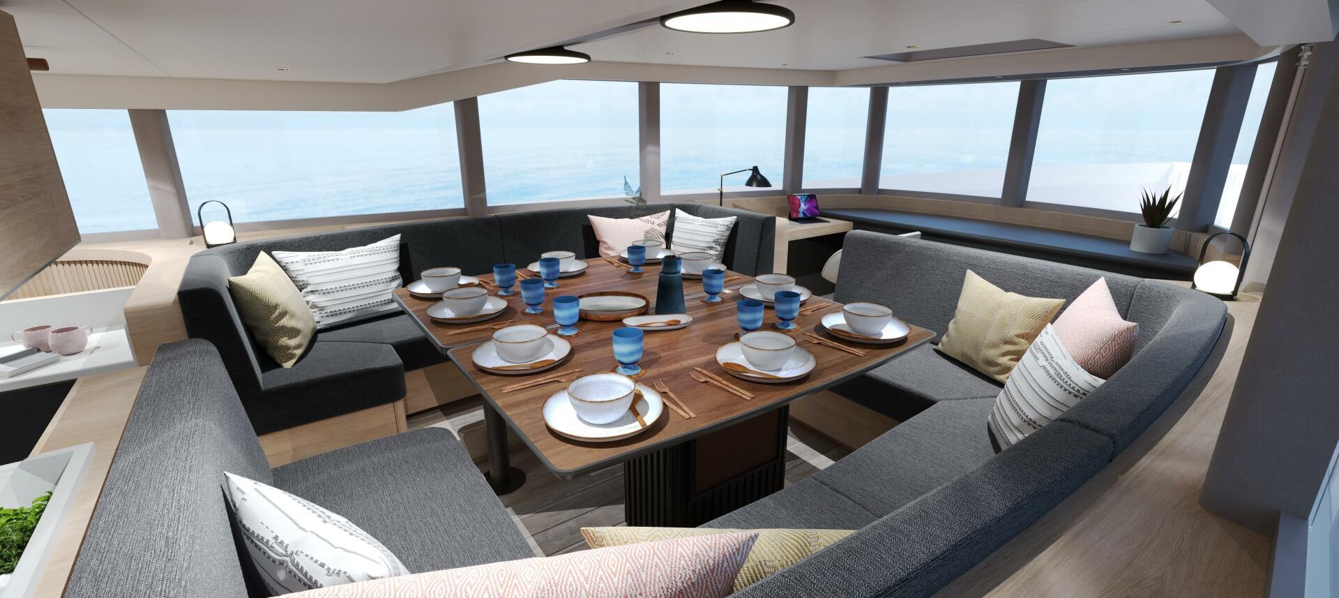 a large living room with a large table and chairs aboard PROJECT OCEAN Yacht for Sale