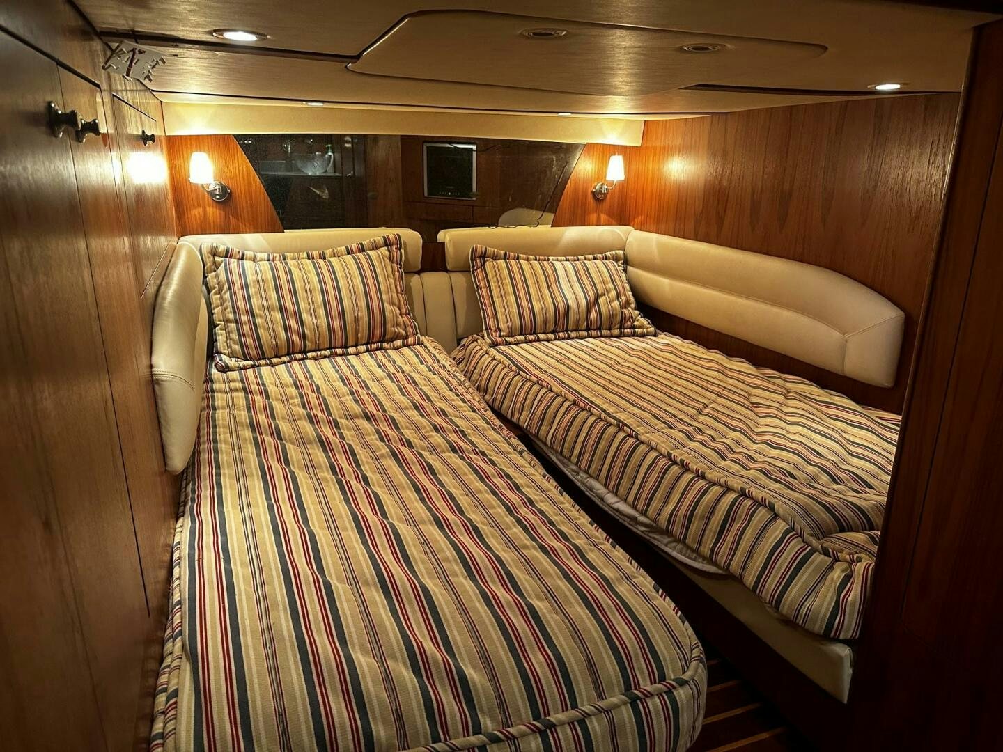 a couple of beds in a room aboard CRYSTAL II Yacht for Sale