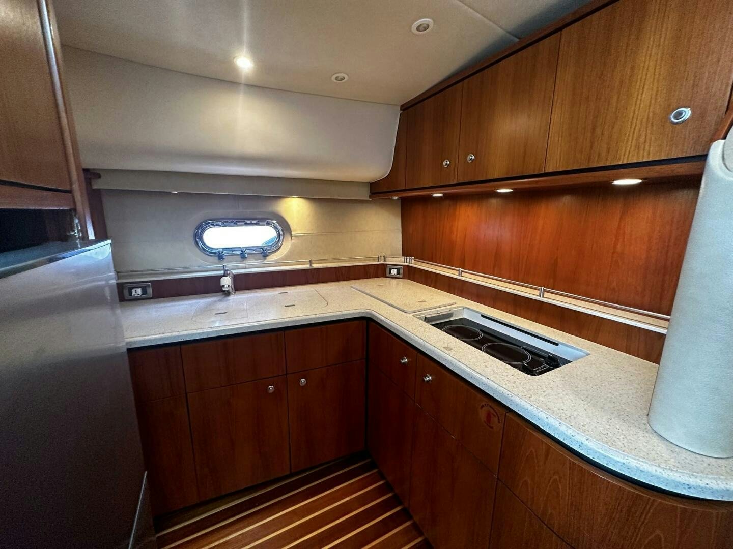 a kitchen with wooden cabinets aboard CRYSTAL II Yacht for Sale