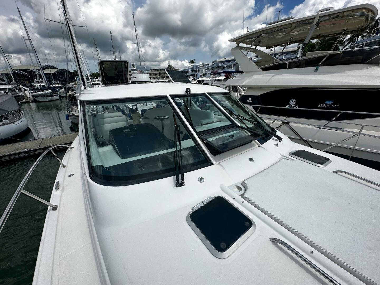 a white yacht in a harbor aboard CRYSTAL II Yacht for Sale
