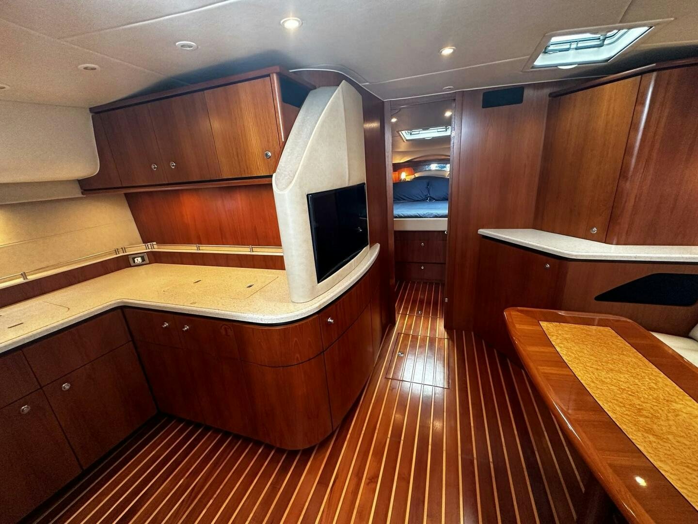 a room with a wood floor and a tv on the wall aboard CRYSTAL II Yacht for Sale