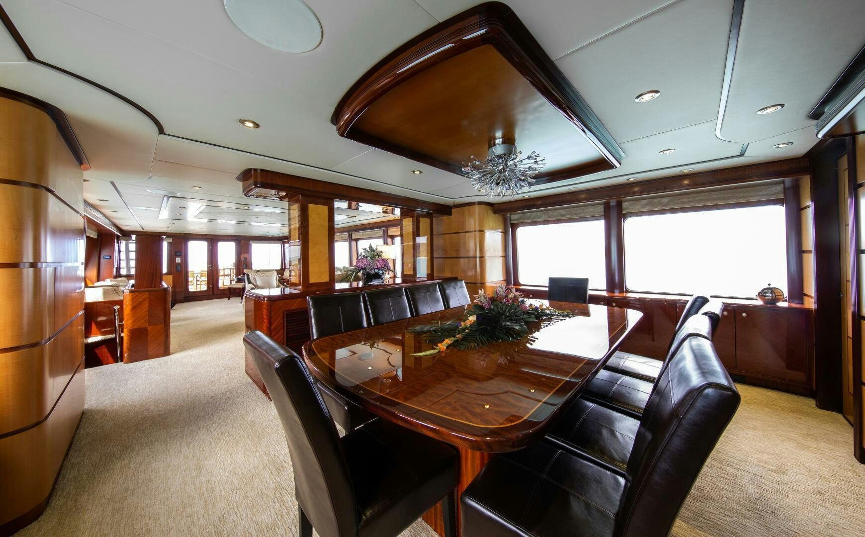 a dining room with a large chandelier aboard JUST ENOUGH Yacht for Sale