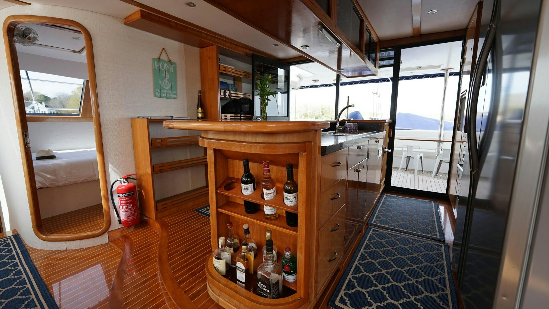 a room with a table and bottles on the shelves aboard SOVEREIGN Yacht for Sale