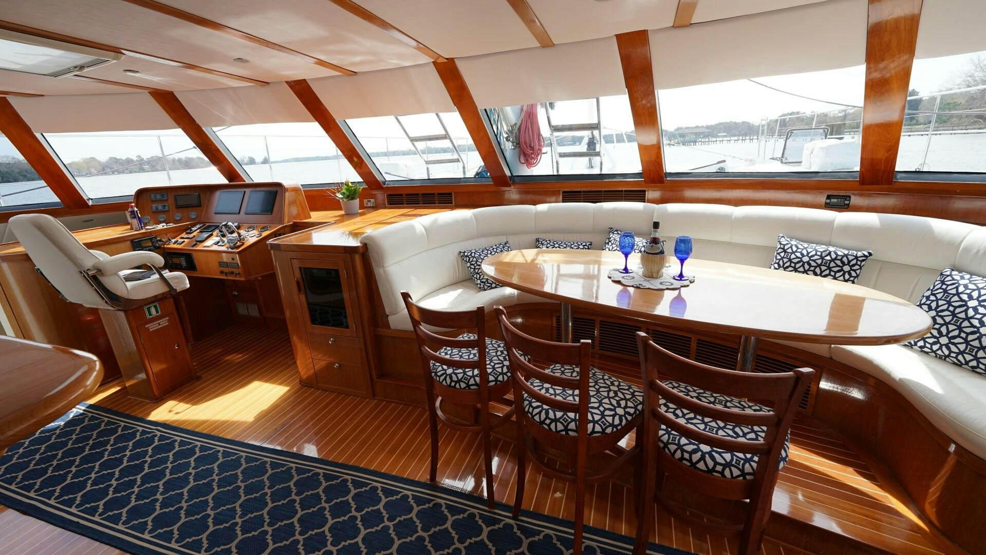 a room with a table and chairs aboard SOVEREIGN Yacht for Sale