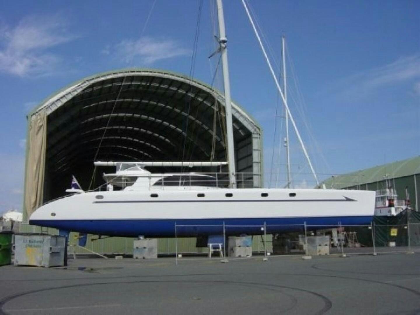 a large white boat in a dock aboard SOVEREIGN Yacht for Sale