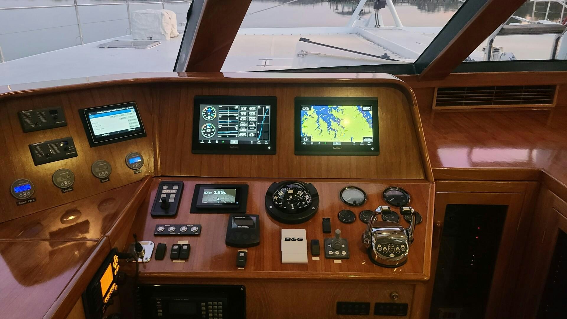 a wooden panel with buttons and dials aboard SOVEREIGN Yacht for Sale
