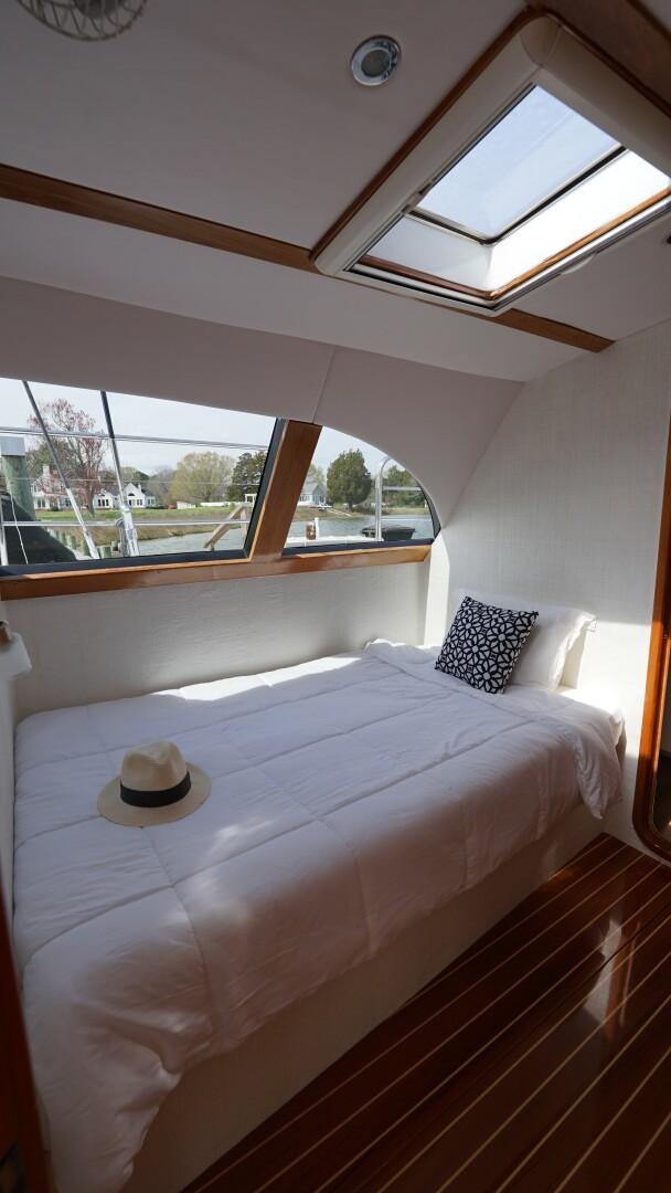a bed with a hat on it aboard SOVEREIGN Yacht for Sale