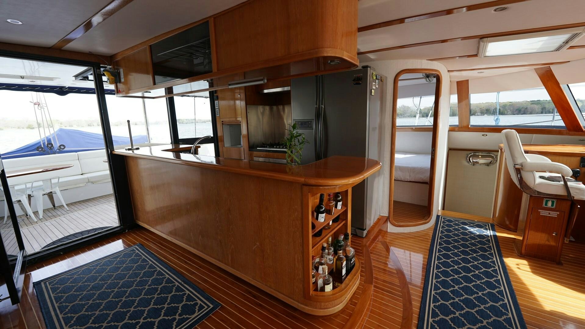 a bar with a counter and chairs aboard SOVEREIGN Yacht for Sale