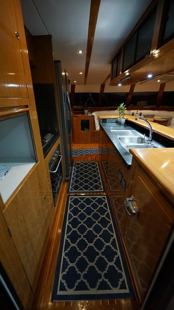 a kitchen with a tile floor aboard SOVEREIGN Yacht for Sale