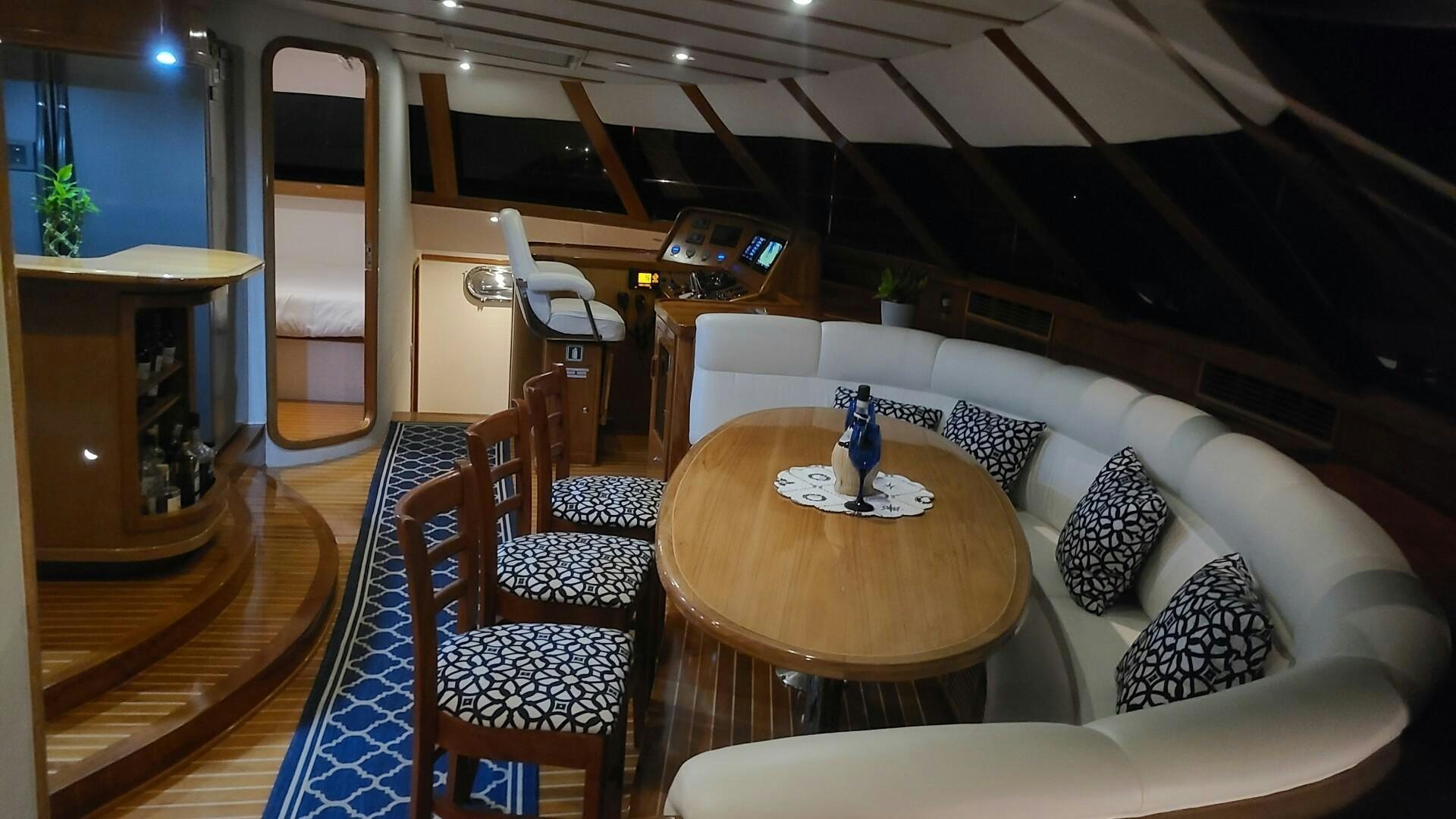 a living room with a couch and a table aboard SOVEREIGN Yacht for Sale