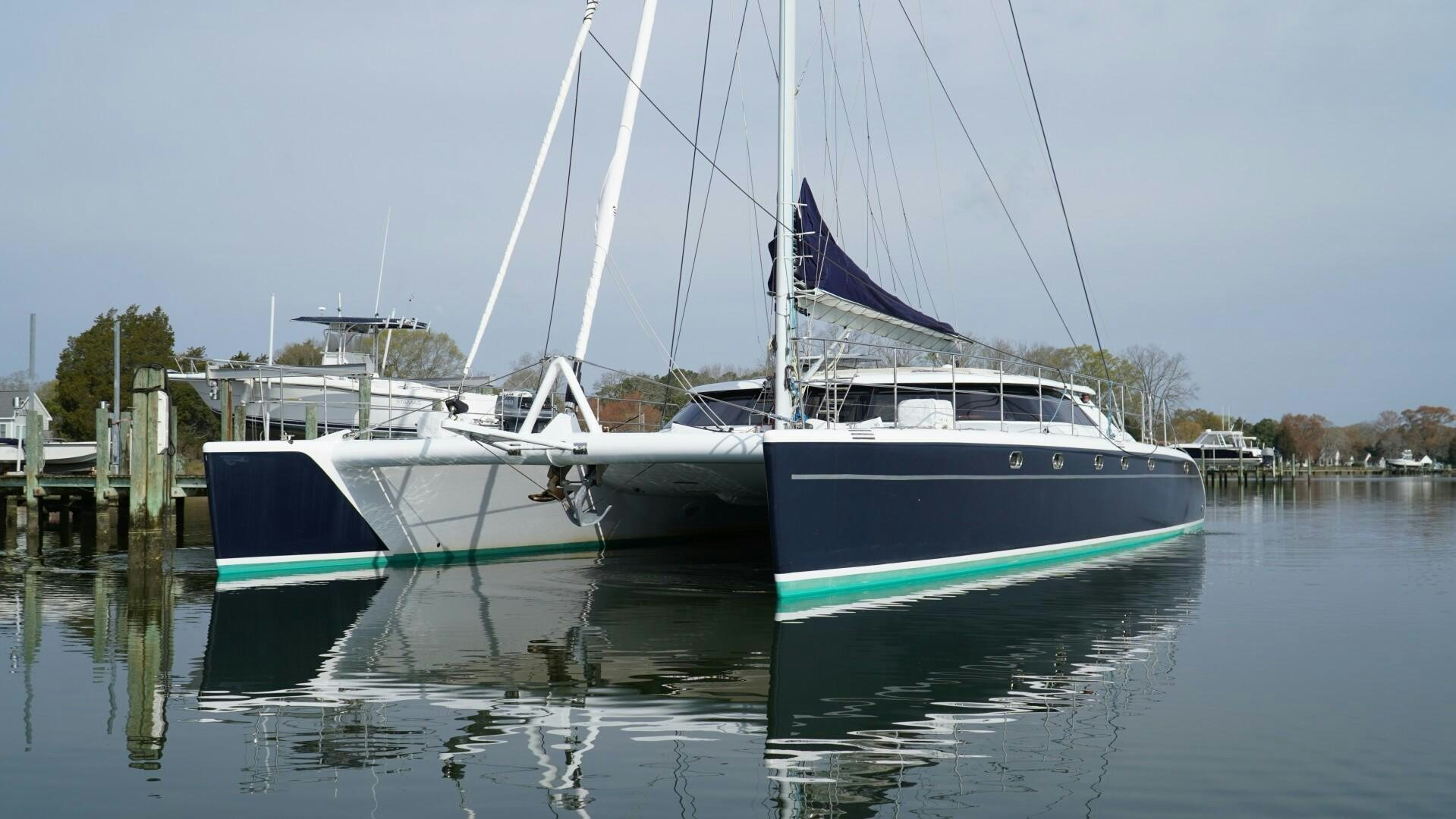 a couple of boats sit in a harbor aboard SOVEREIGN Yacht for Sale
