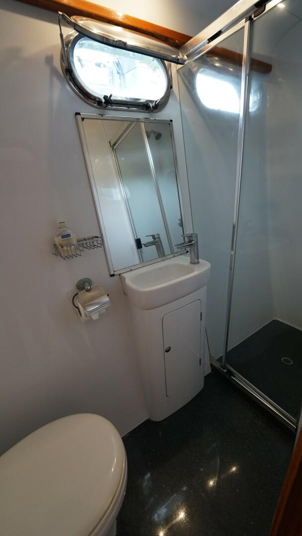 a bathroom with a sink and a mirror aboard SOVEREIGN Yacht for Sale