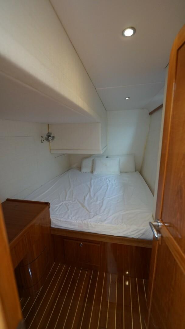 a bed with white sheets aboard SOVEREIGN Yacht for Sale