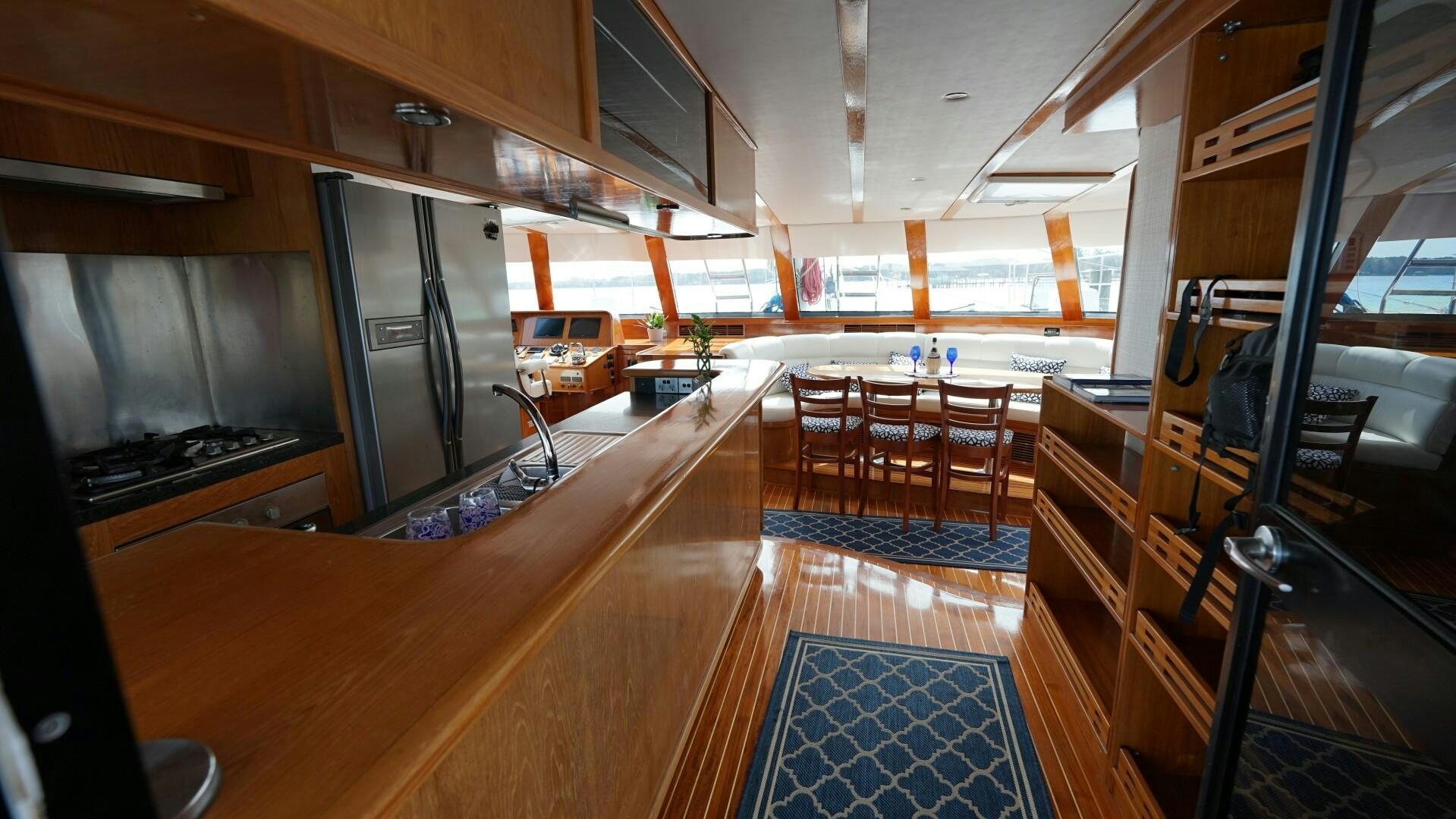a kitchen with a bar and a bar aboard SOVEREIGN Yacht for Sale