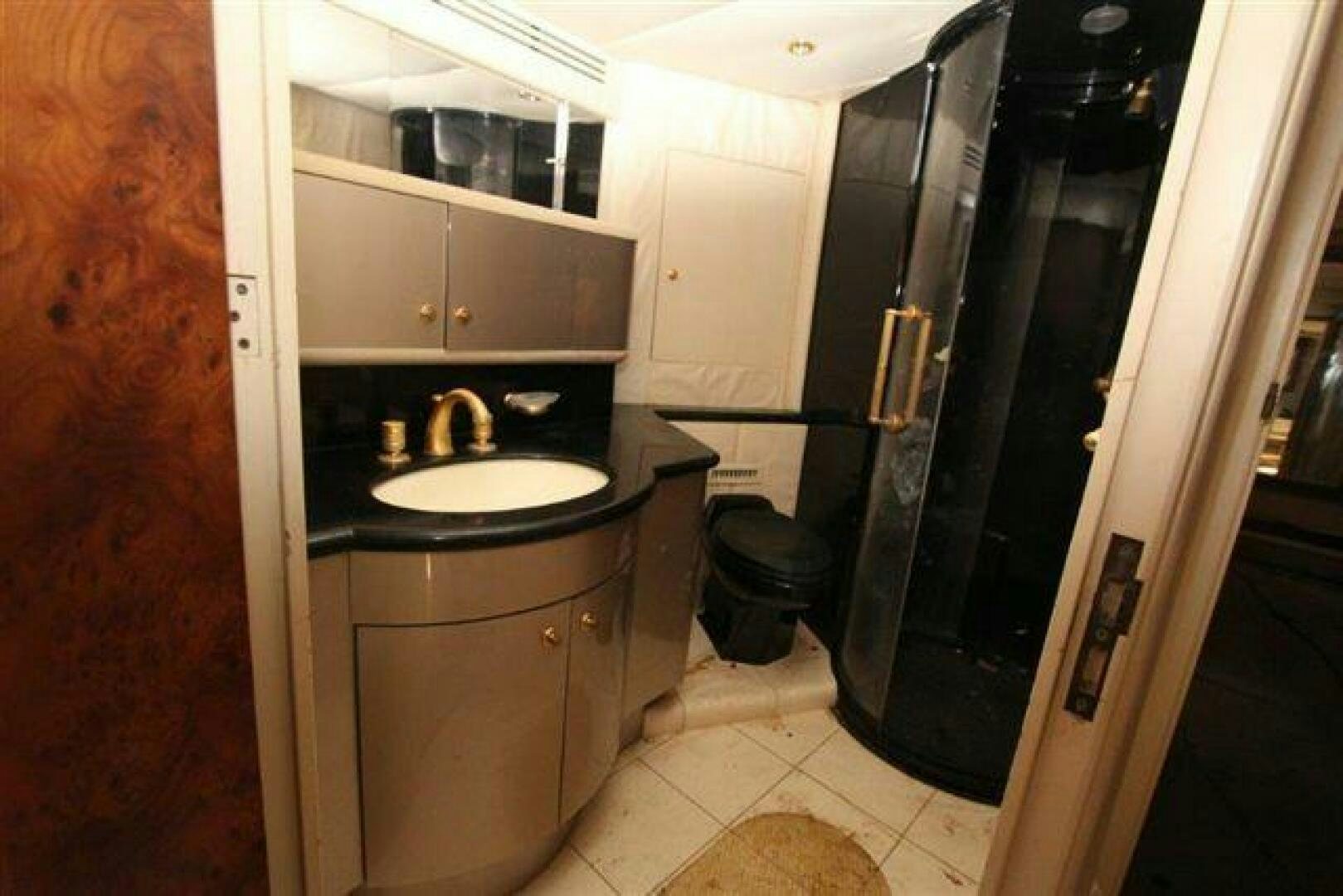 a kitchen with black appliances aboard PRICELESS Yacht for Sale