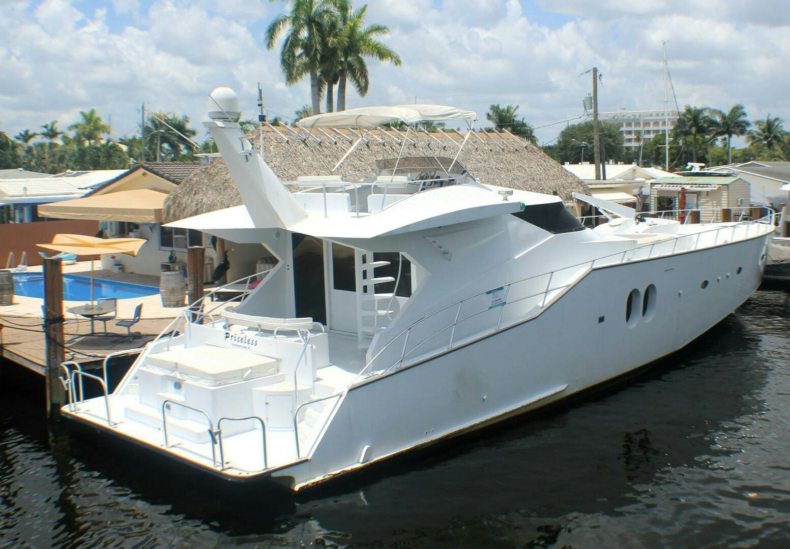 a boat docked at a pier aboard PRICELESS Yacht for Sale