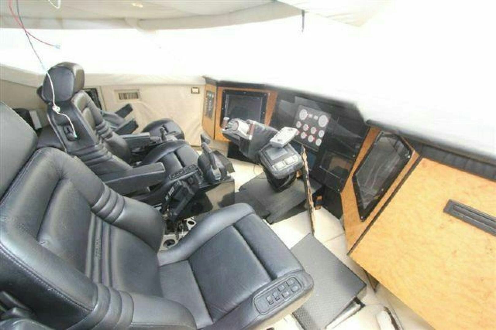 a room with chairs and a table aboard PRICELESS Yacht for Sale