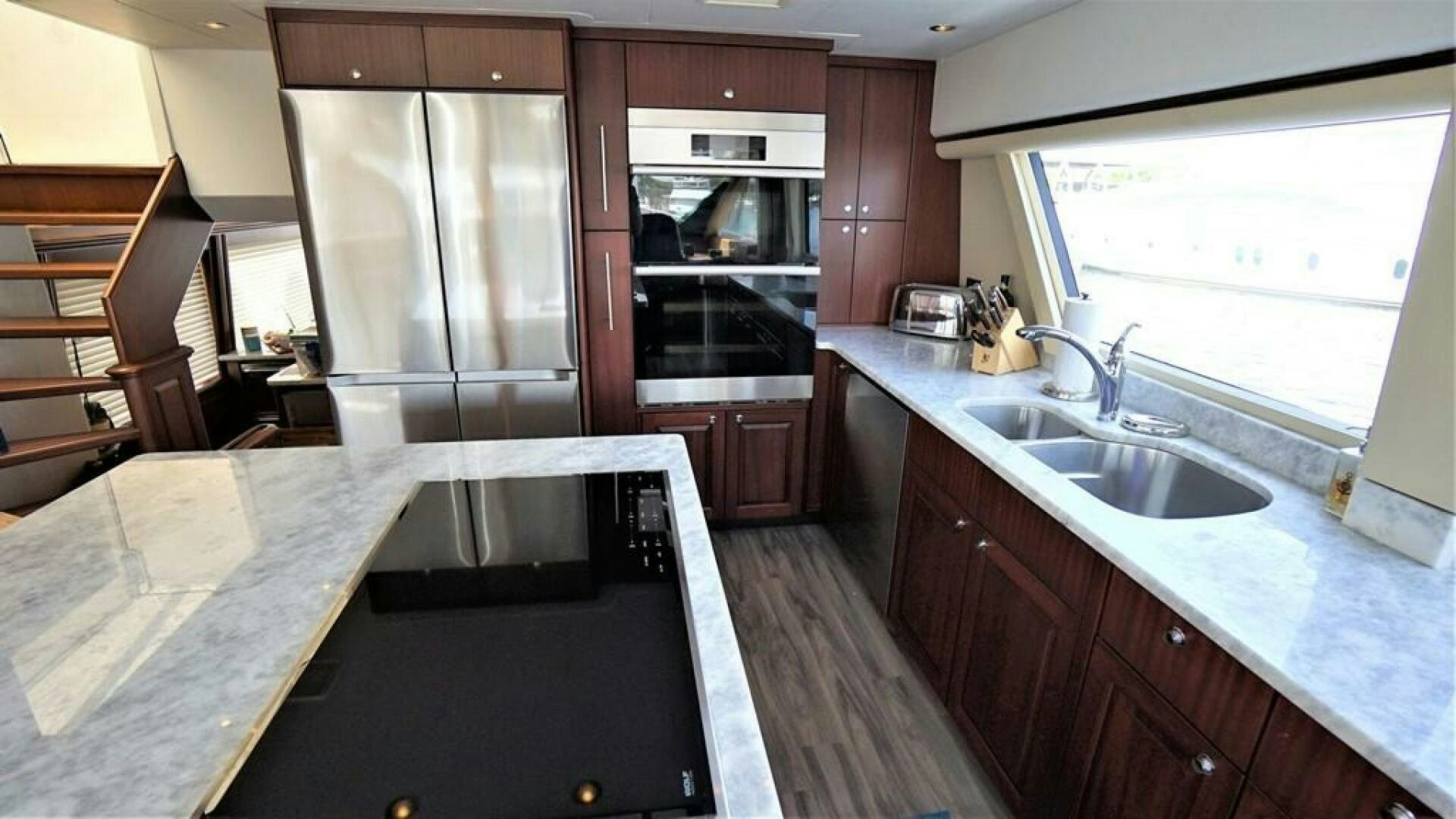 a kitchen with a stainless steel refrigerator aboard LADY B Yacht for Sale
