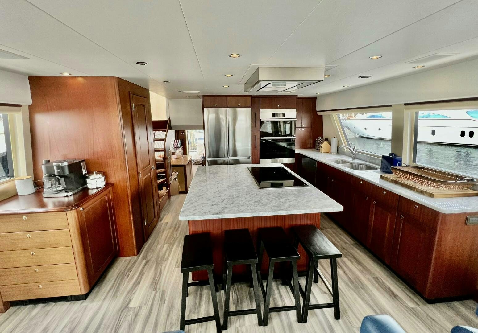 a kitchen with a bar stools and a bar stools aboard LADY B Yacht for Sale