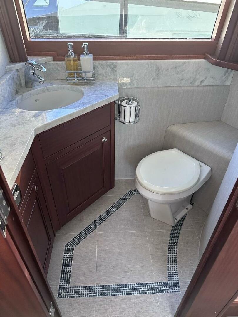 a bathroom with a sink toilet and a bathtub aboard LADY B Yacht for Sale