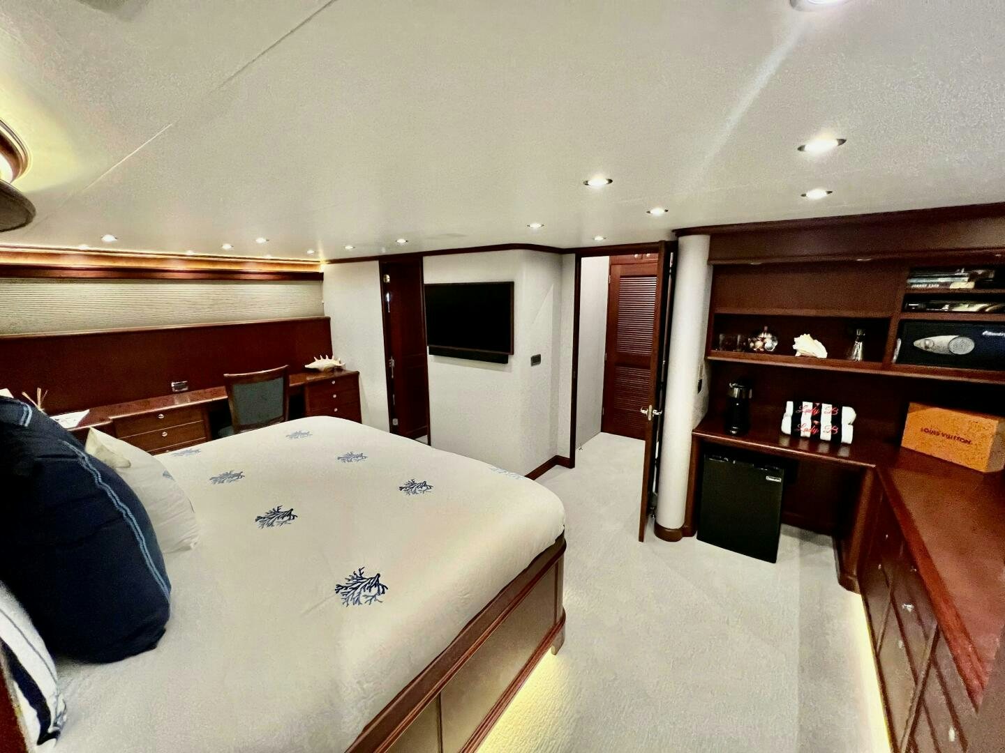 a bedroom with a bed and desk aboard LADY B Yacht for Sale