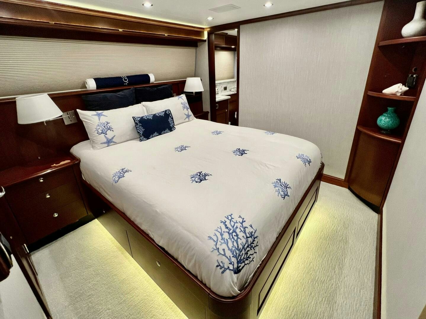 a bed with blue and white sheets aboard LADY B Yacht for Sale