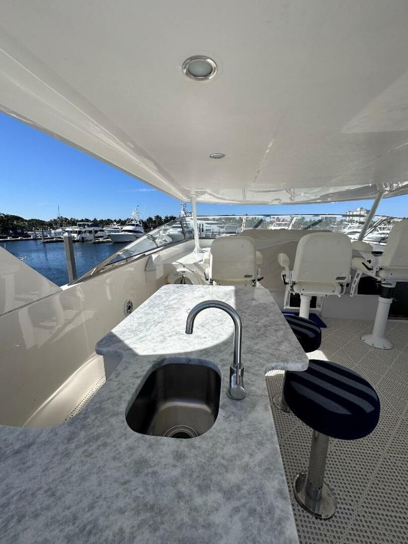 a group of chairs on a deck overlooking a body of water aboard LADY B Yacht for Sale