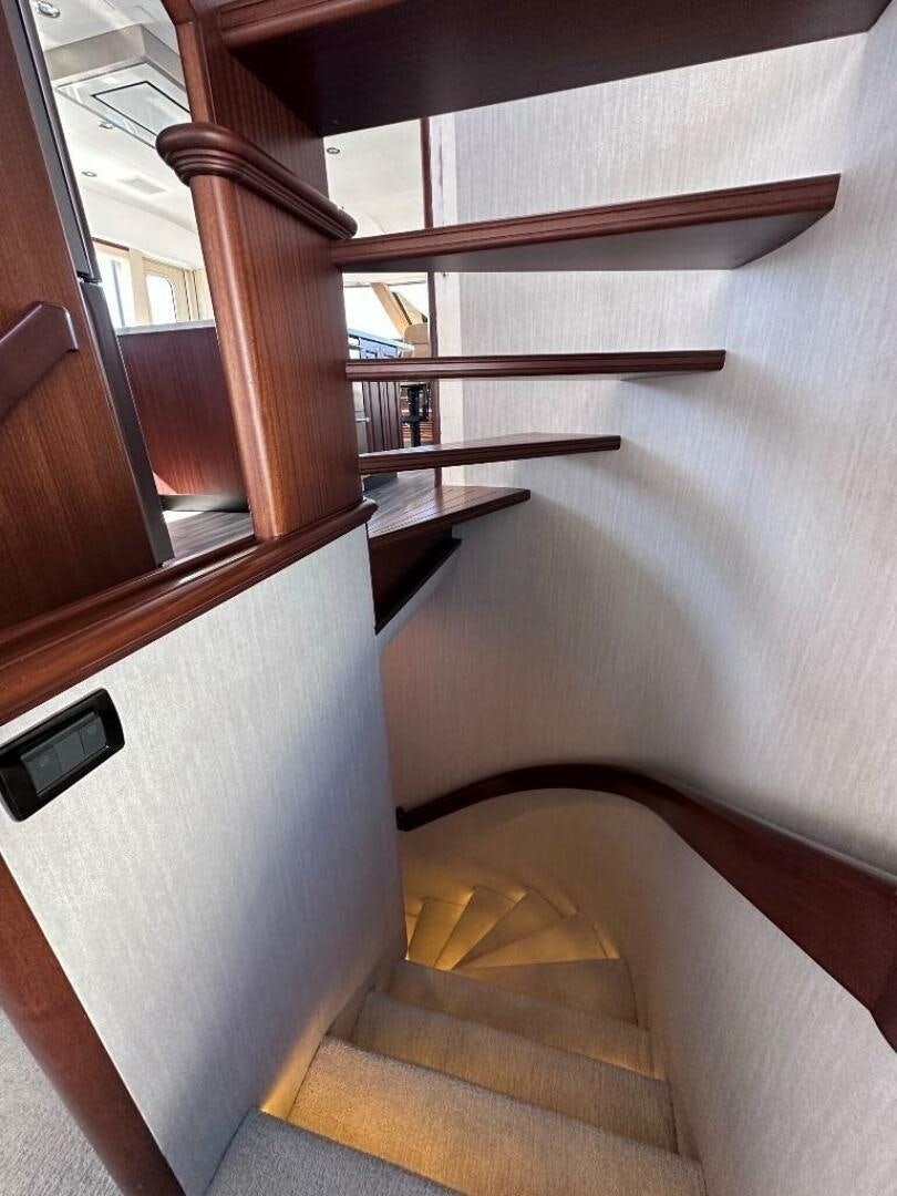a wooden staircase with a glass door aboard LADY B Yacht for Sale