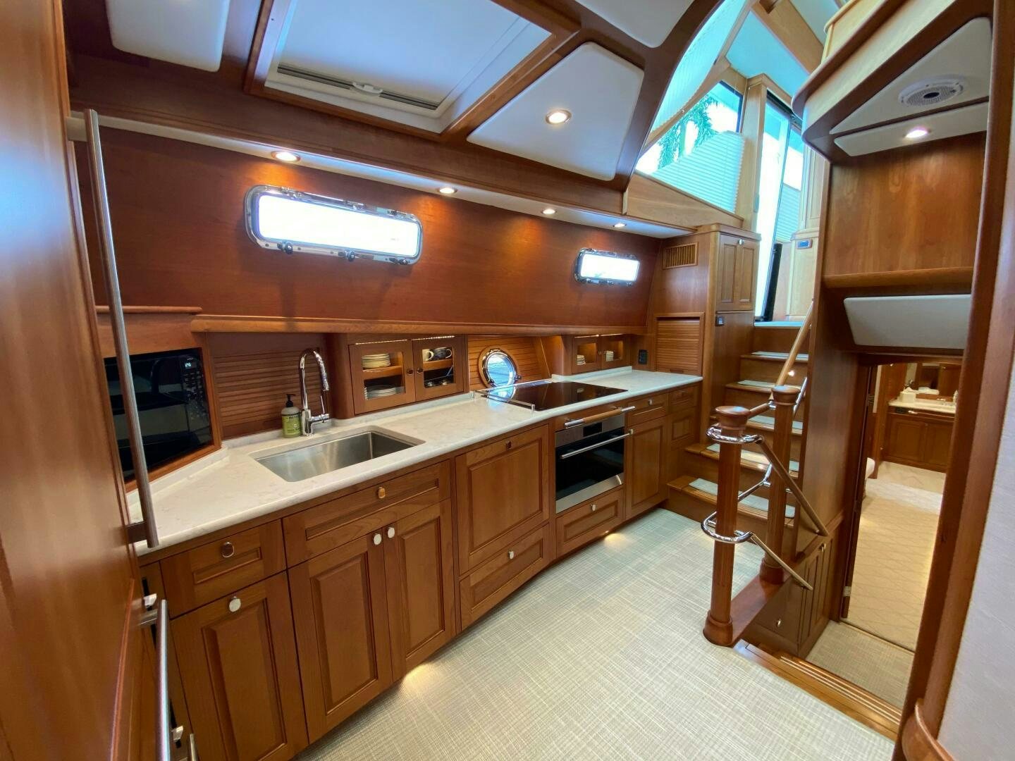 a kitchen with wooden cabinets aboard WHIRL AWAY Yacht for Sale