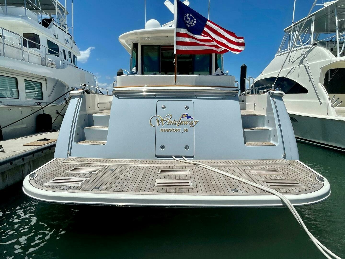 a boat with a flag on the front aboard WHIRL AWAY Yacht for Sale