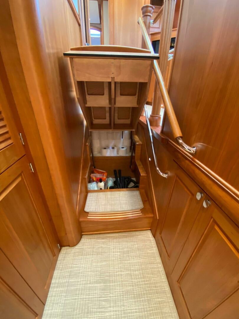 a wooden staircase with a glass case aboard WHIRL AWAY Yacht for Sale