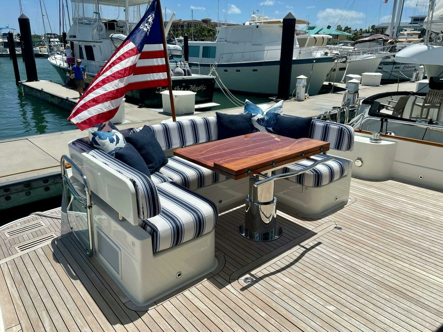 a boat with a flag on the deck aboard WHIRL AWAY Yacht for Sale