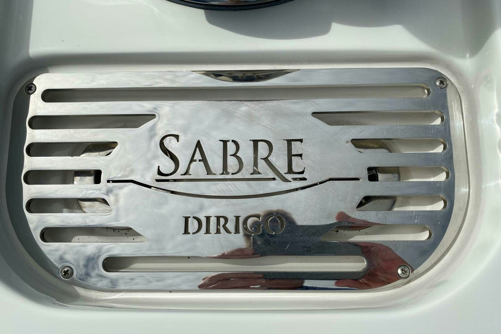 a silver can with a pair of scissors and a red ribbon aboard WHIRL AWAY Yacht for Sale