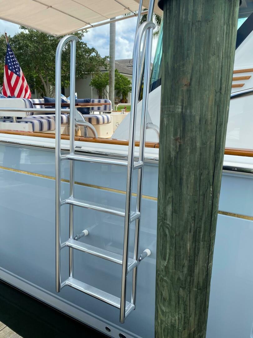 a boat with a flag on the deck aboard WHIRL AWAY Yacht for Sale