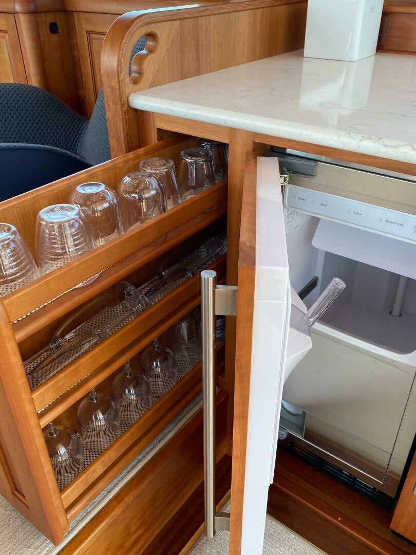 a shelf with glasses and bottles aboard WHIRL AWAY Yacht for Sale