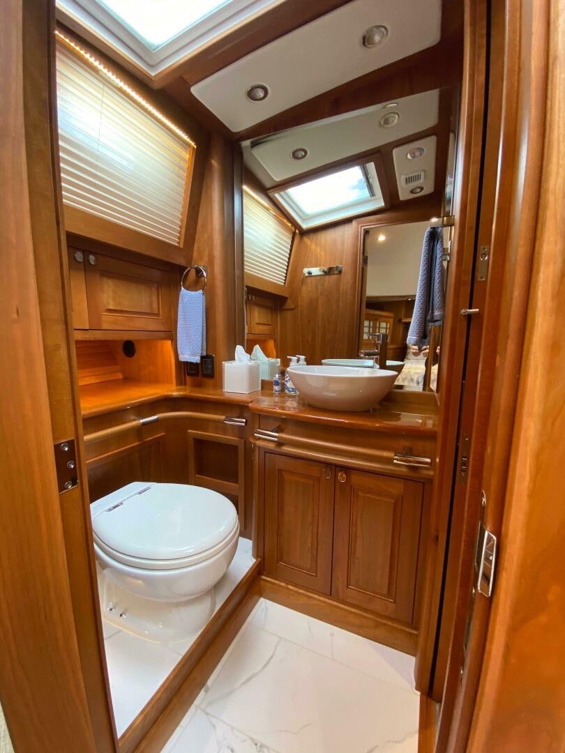 a bathroom with a toilet and a sink aboard WHIRL AWAY Yacht for Sale