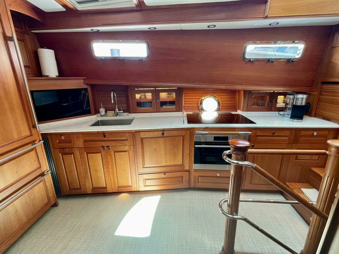 a kitchen with wooden cabinets aboard WHIRL AWAY Yacht for Sale