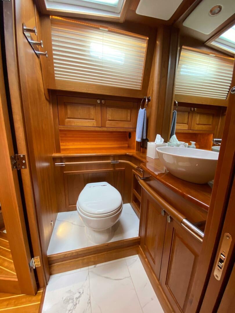 a bathroom with wooden cabinets aboard WHIRL AWAY Yacht for Sale